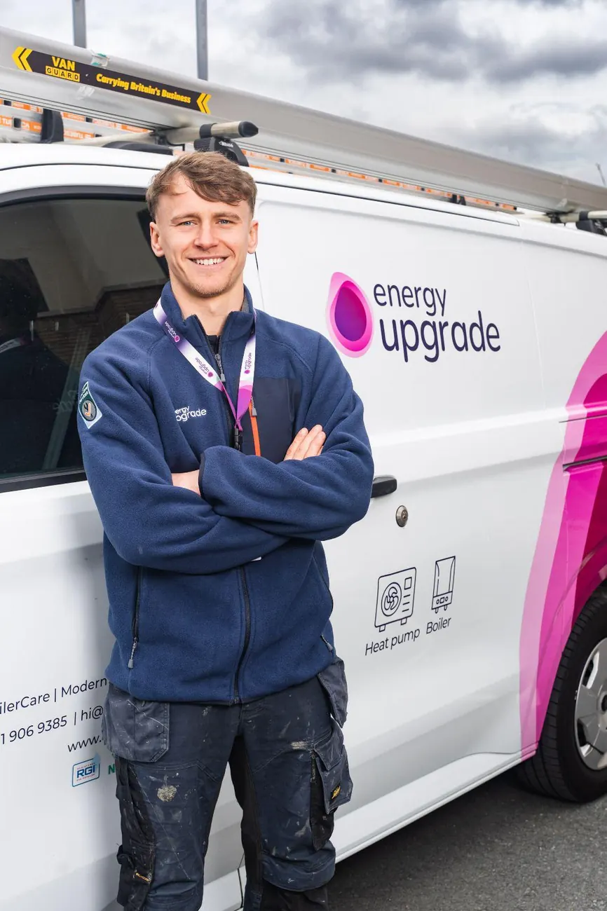 Energy Upgrade engineer with arms folded by the company van