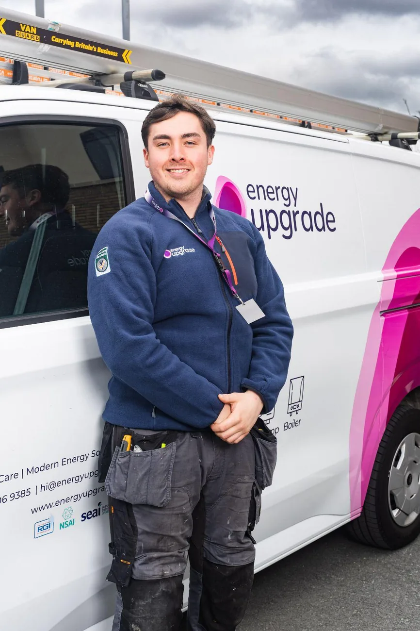 Energy Upgrade engineer in the company fleece by a van