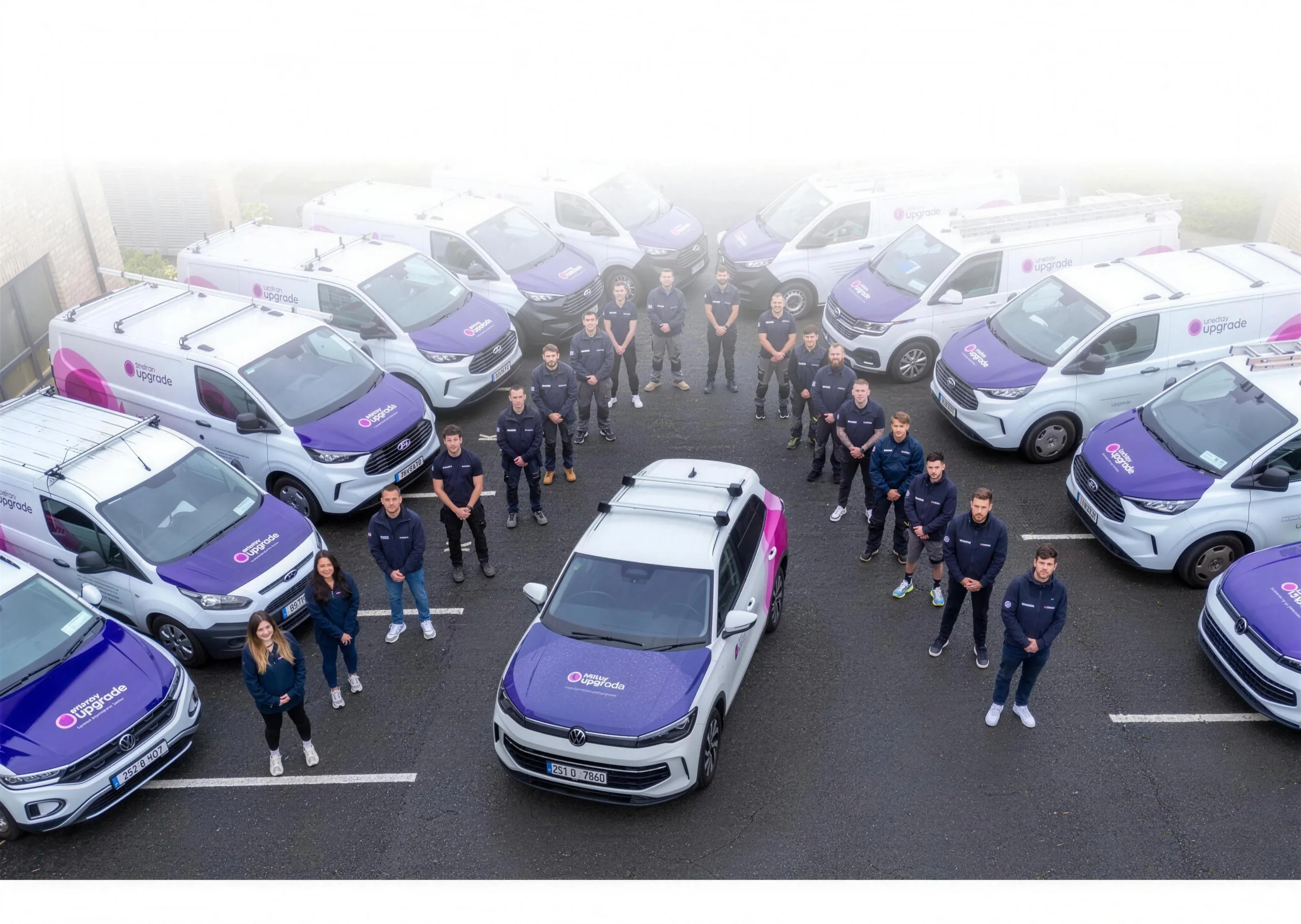 The Energy Upgrade team standing together in front of the company vans