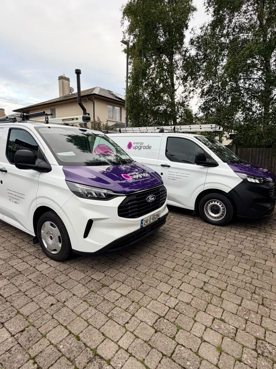 An Energy Upgrade van parked outside a home